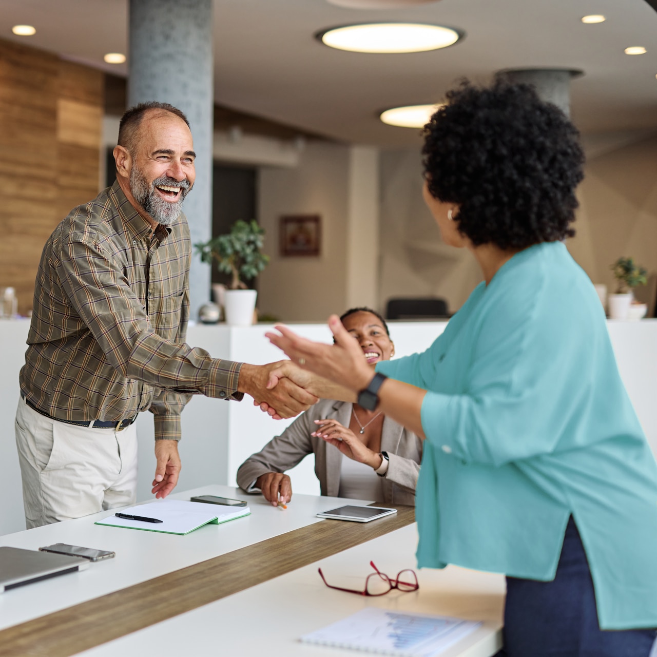 People greeting each other at an office.