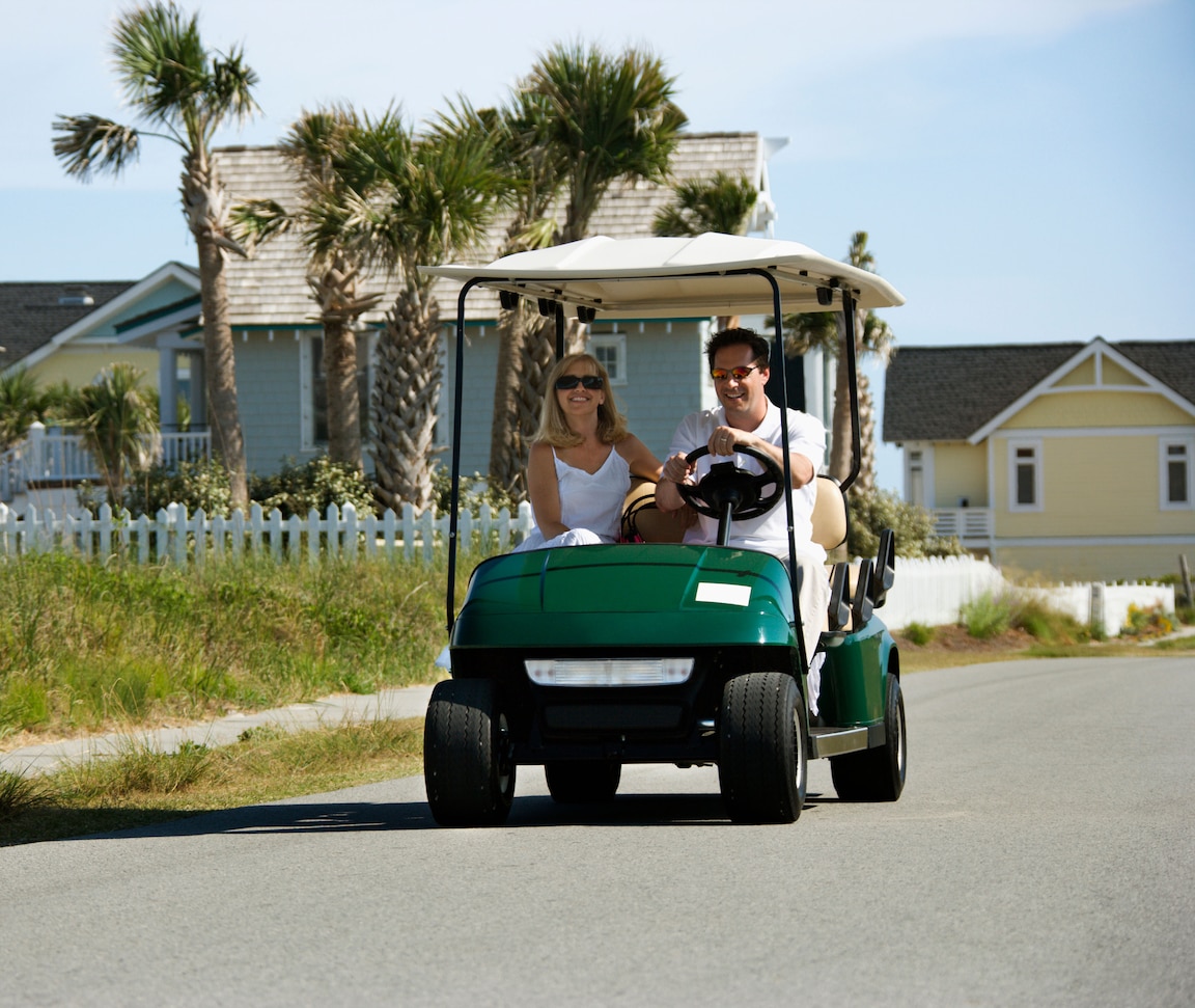 A couple on a golf cart