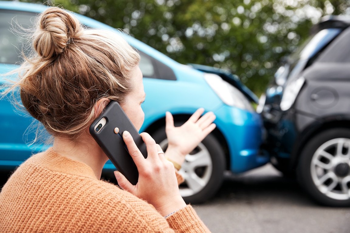 Woman on cell phone with Liberty mutual after a car accident