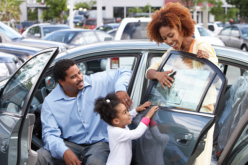 Family looking at a new car