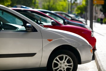 Different cars lined up on the curb