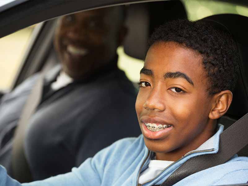 Father teaching his teenage son to drive