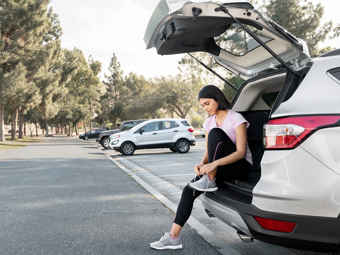 Woman with her car about to go for a run