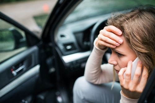 Woman on the phone in her car