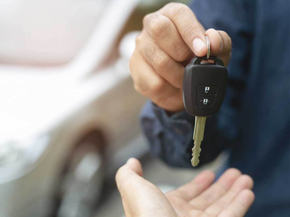 Car keys being handed to new owner