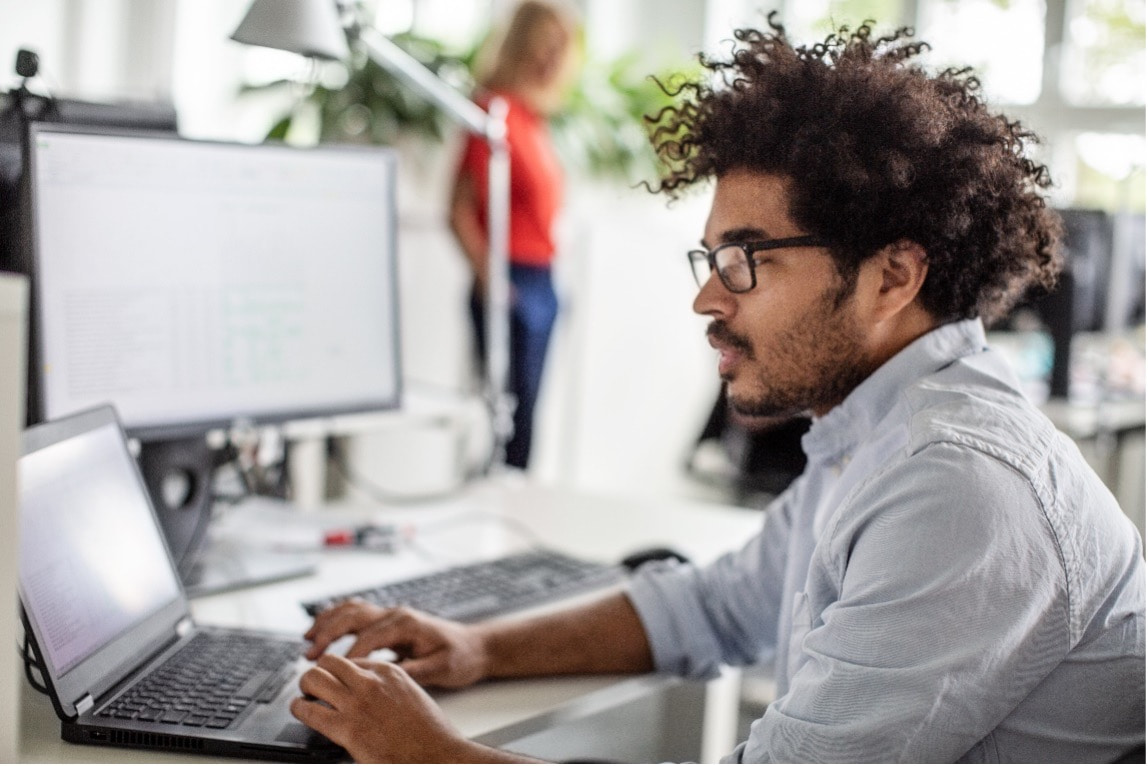 man working in office at his laptop