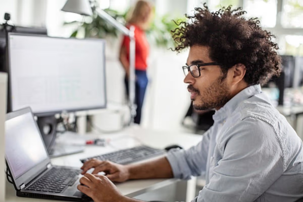 man working in office at his laptop
