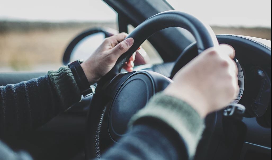 hands on a car steering wheel