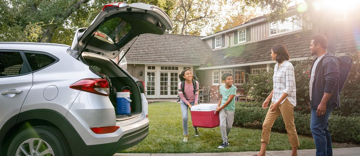 Family packing their car up to go camping