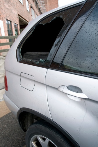 father leaning in window talking to daughter in driver seat