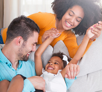 Mother and father playing with their young daughter