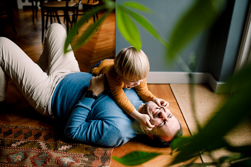 Father on the floor playing with his son