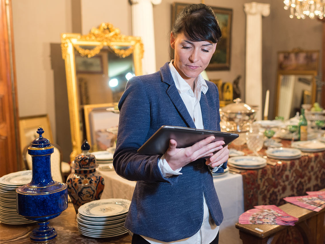 woman in antique shop holding an ipad