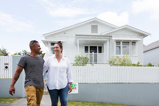 Couple walking away from a house