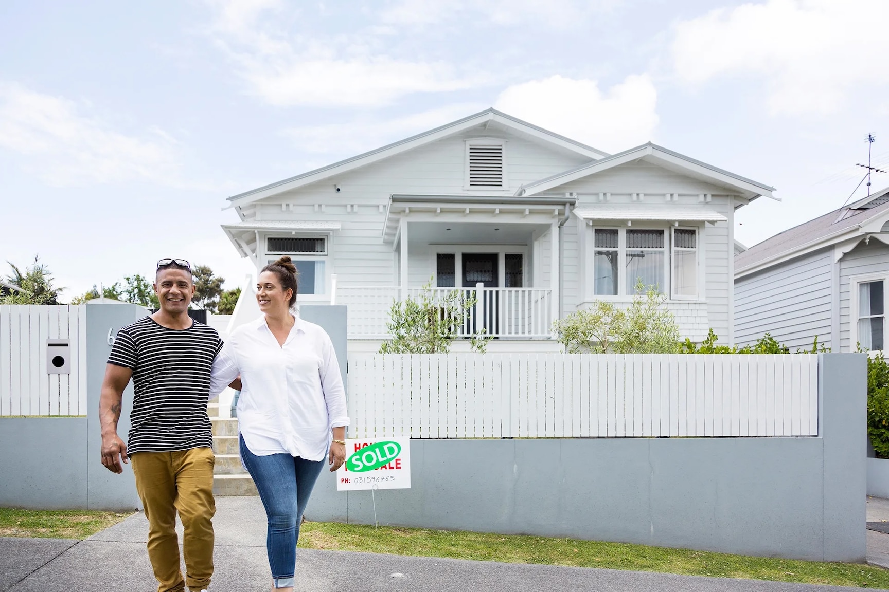 Couple walking away from a house