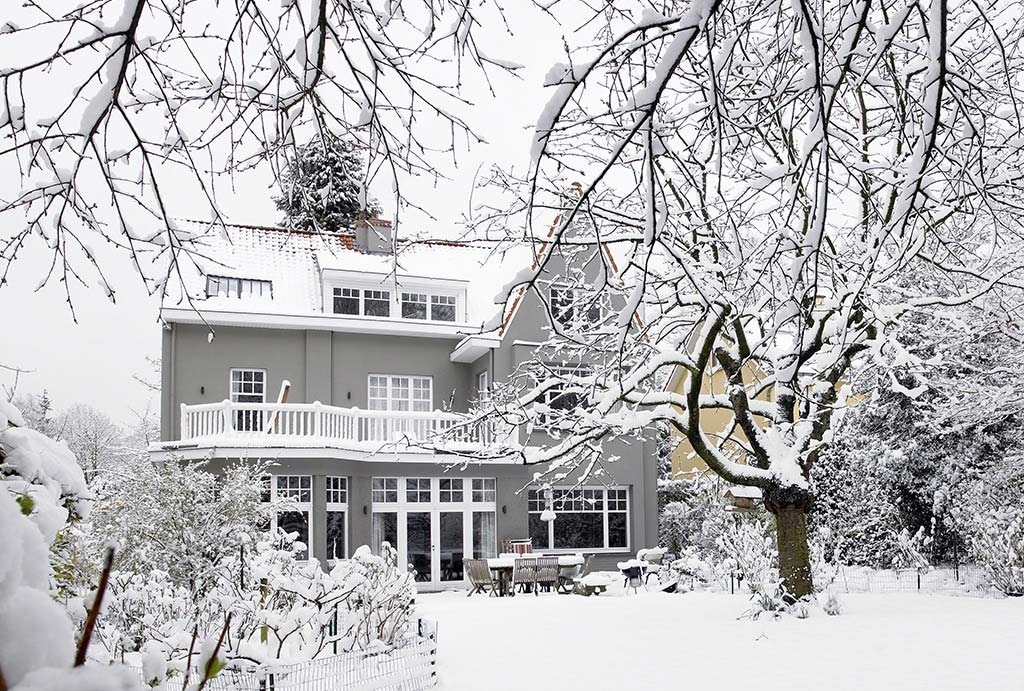 Snow covered house and yard