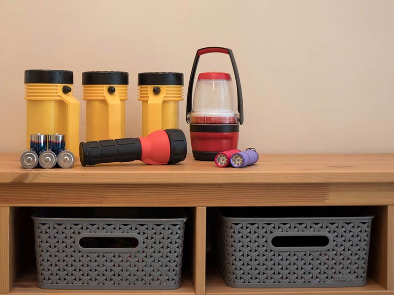 Flashlights, batteries, and other items for a household safety kit 