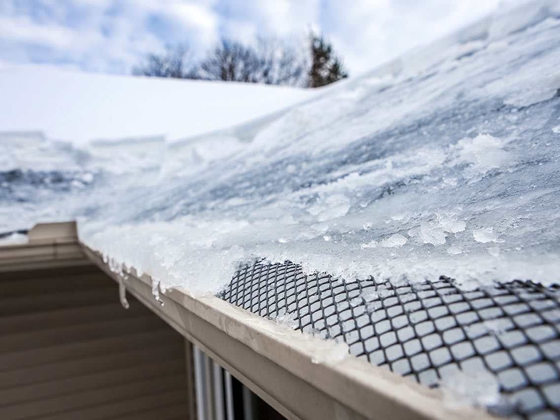 roof and gutters frozen in ice