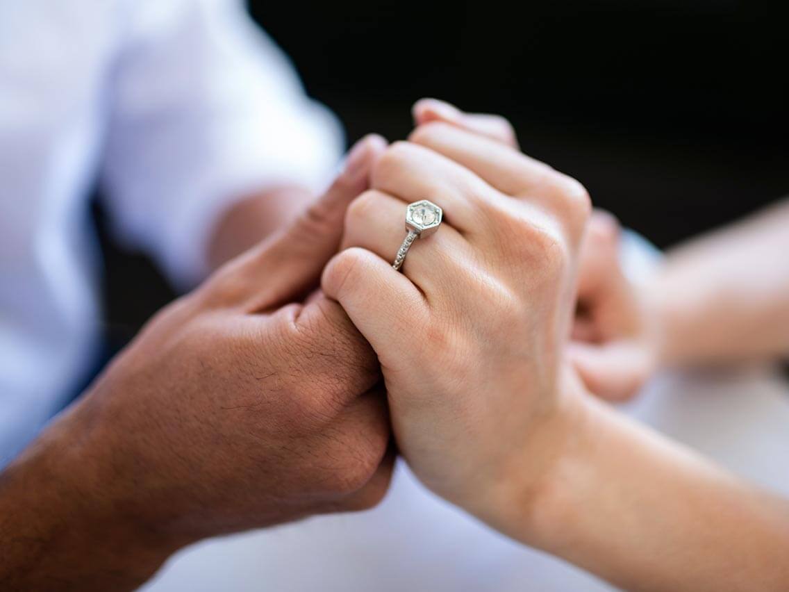 Couple admiring an engagement ring