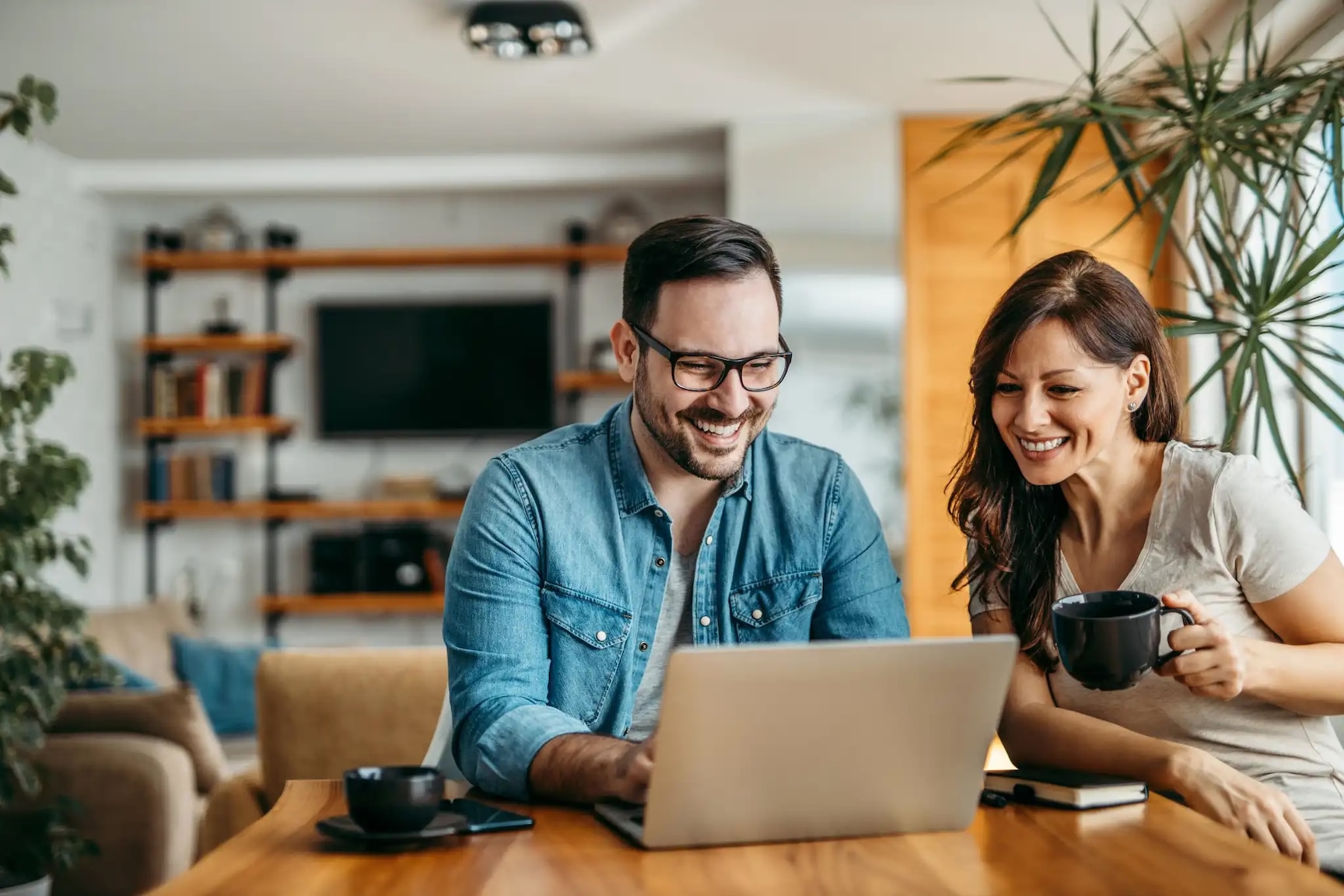 Man and woman looking at a laptop