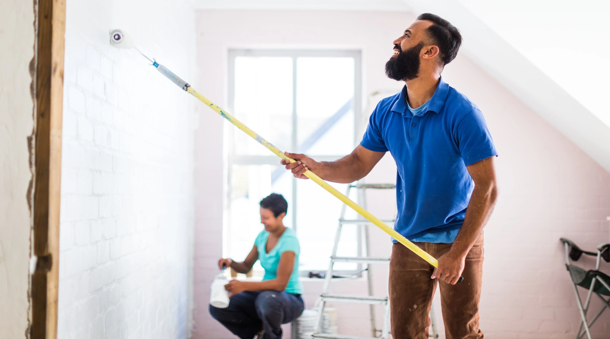 a couple painting their new home