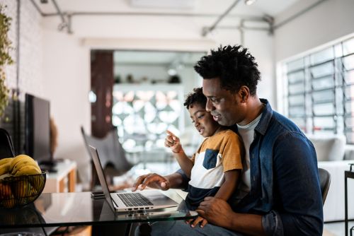 Father and son looking at a laptop together