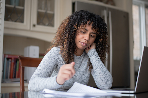 Concerned girl looking at papers