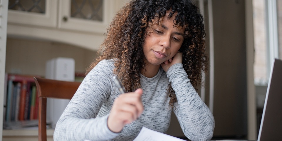 Concerned girl looking at papers