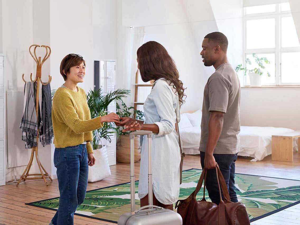 Couple greeting their homeshare host