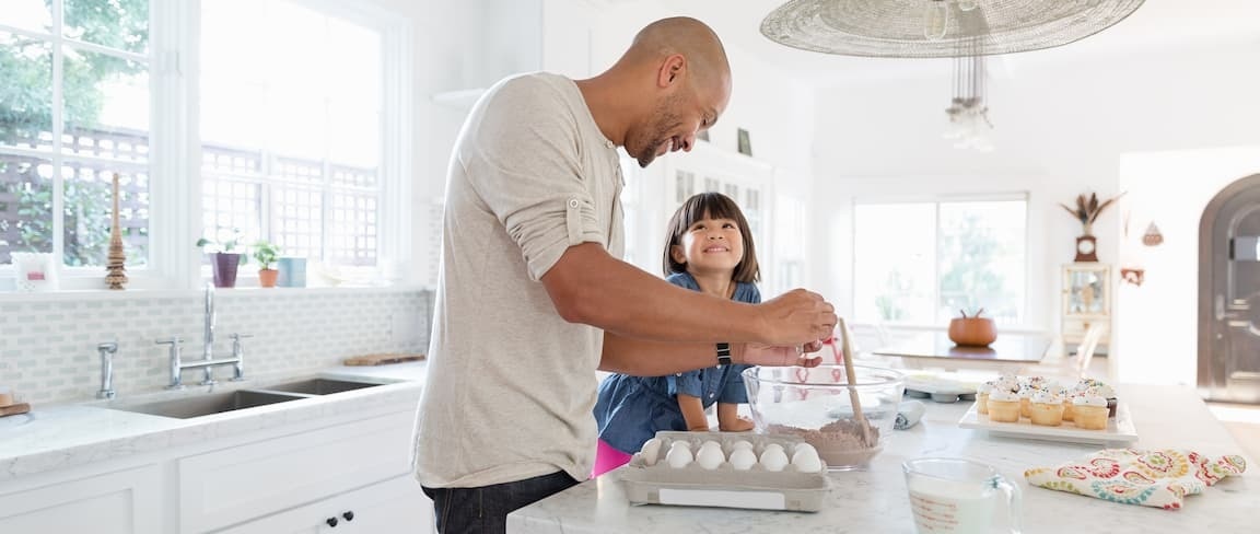 Adult and child baking in the kitchen