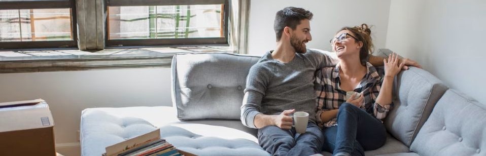 couple sitting on couch in new apartment