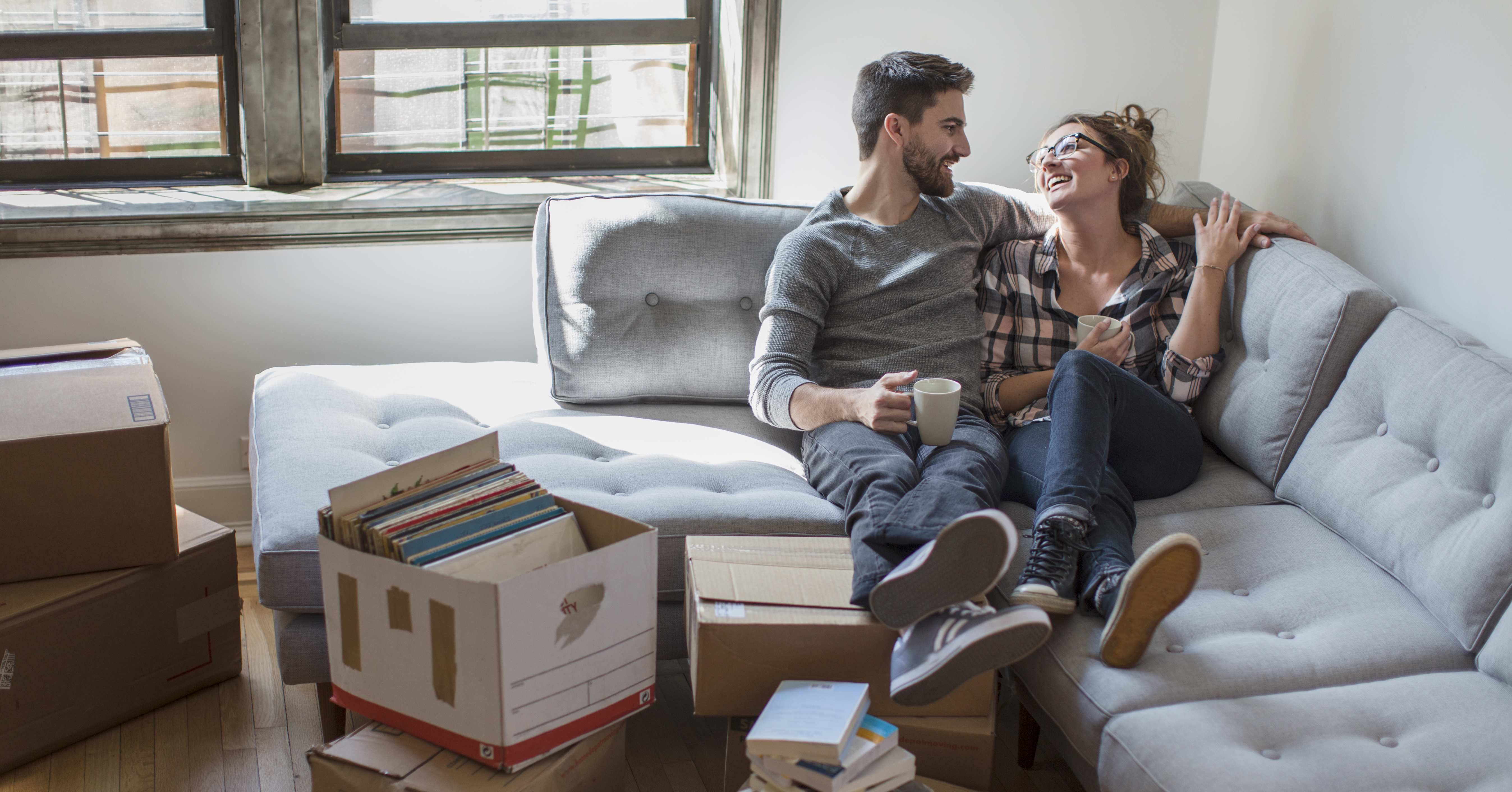 couple sitting on couch in new apartment