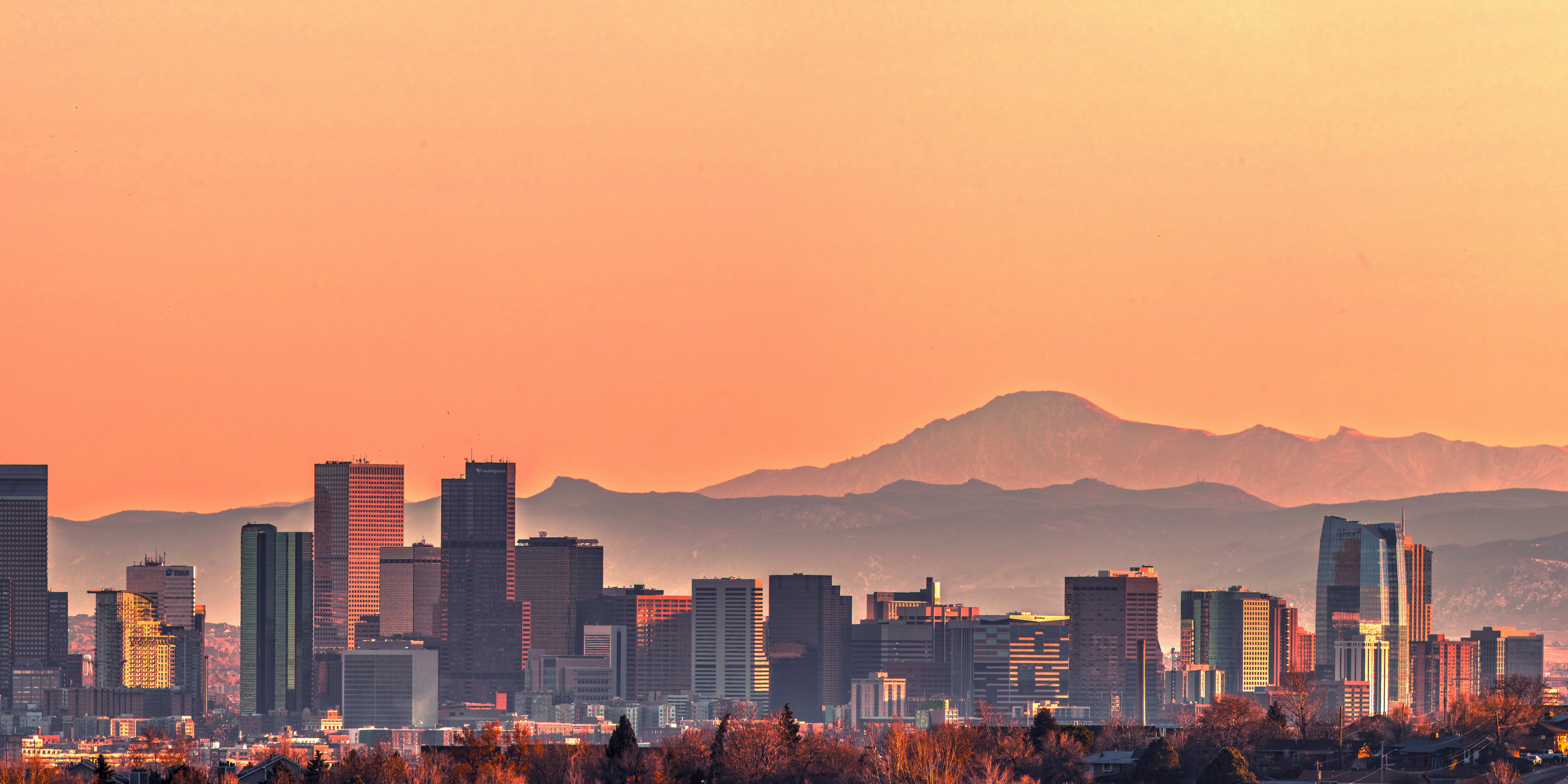 View of city skyline in Colorado with mountains in the background