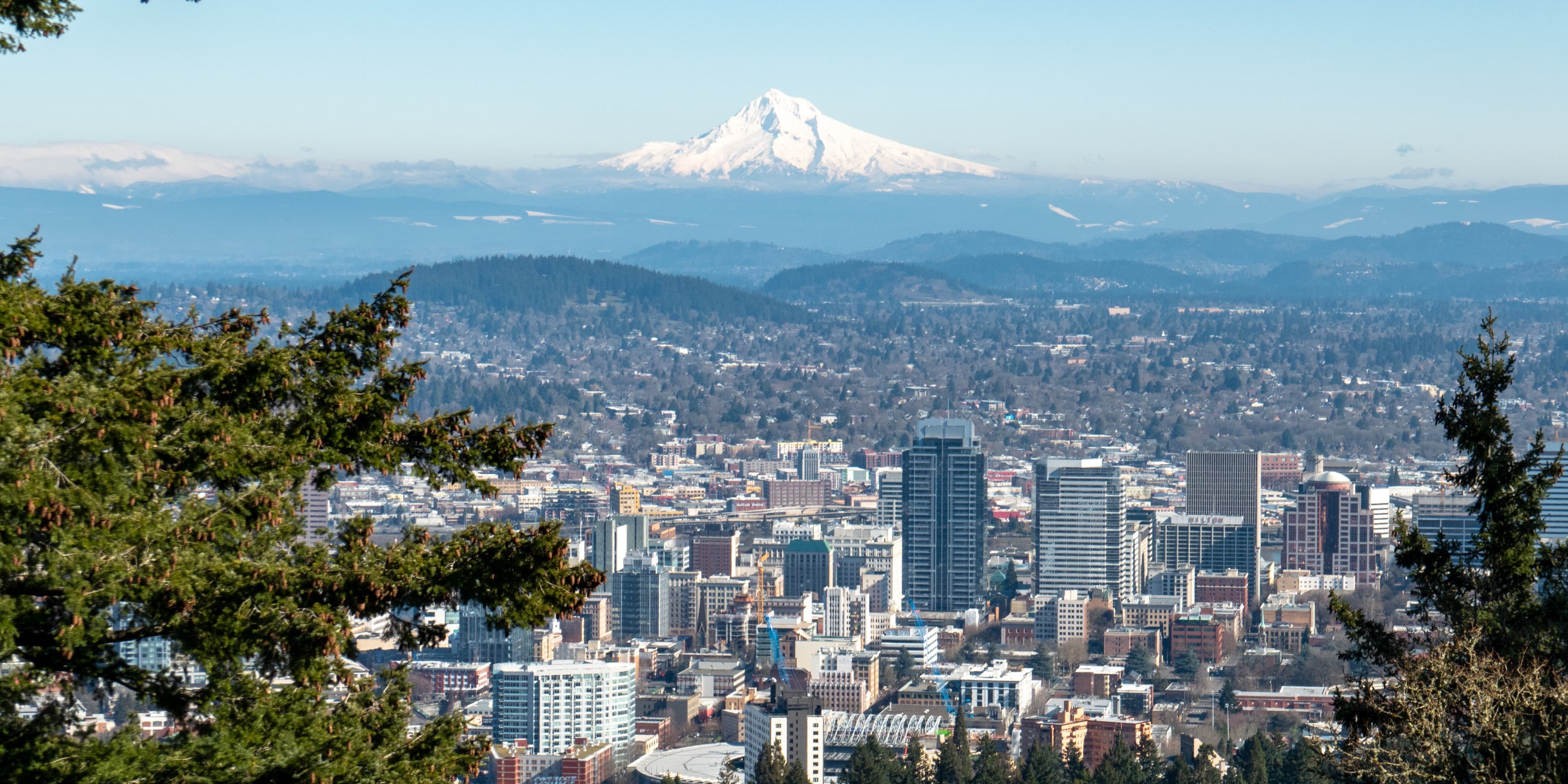 Aerial view of a city in Oregon with an ice covered mountain in the background