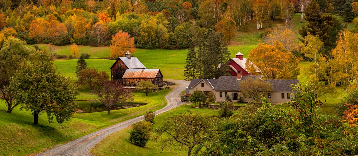 large farm house on large land with a barn