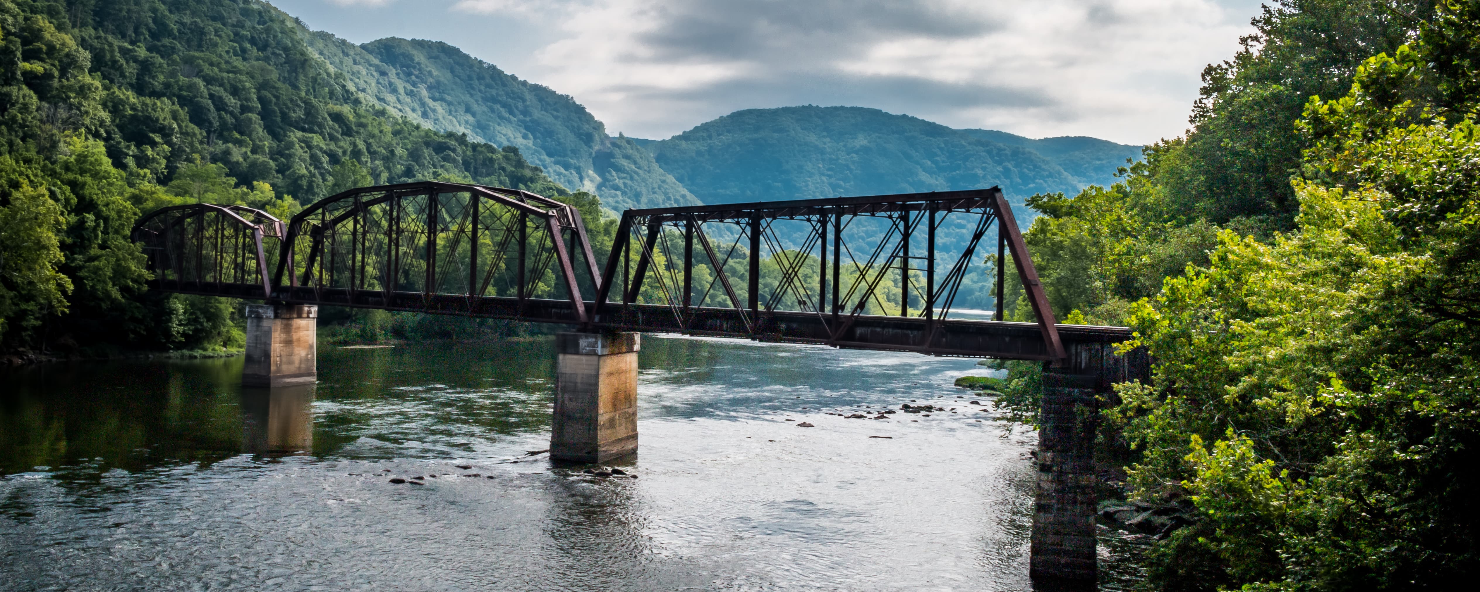 river with train bridge going over it