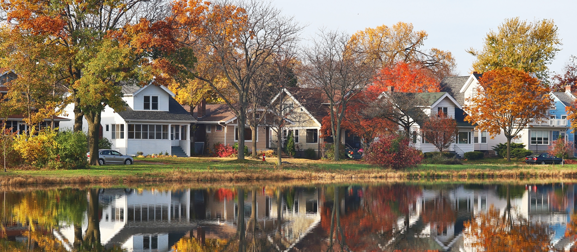 Row of houses in a neighborhood in Wisconsin with pond across the street