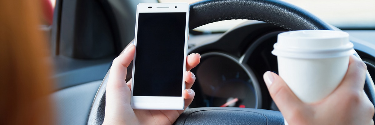 driver with coffee and cell phone driver with coffee and cell phone