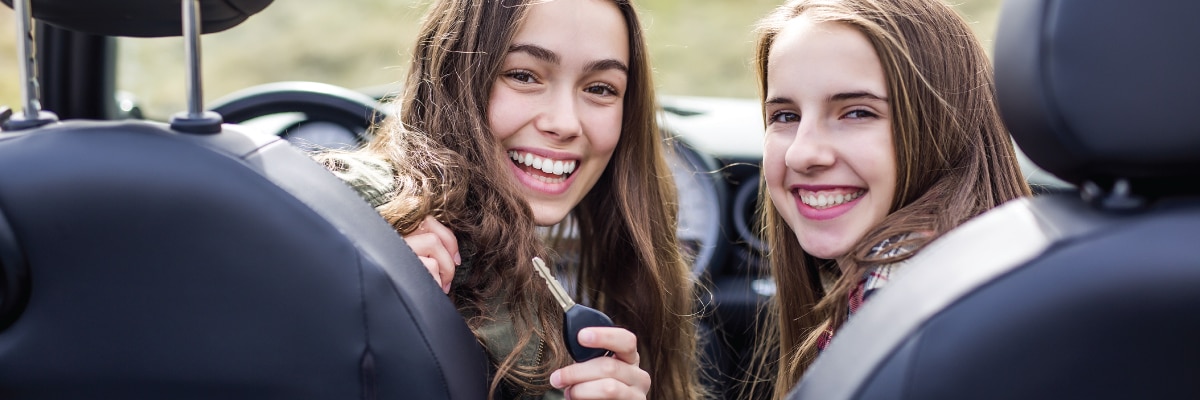 two teens in a car