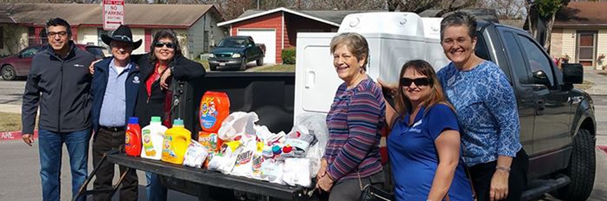 agents donate laundry supplies at local school