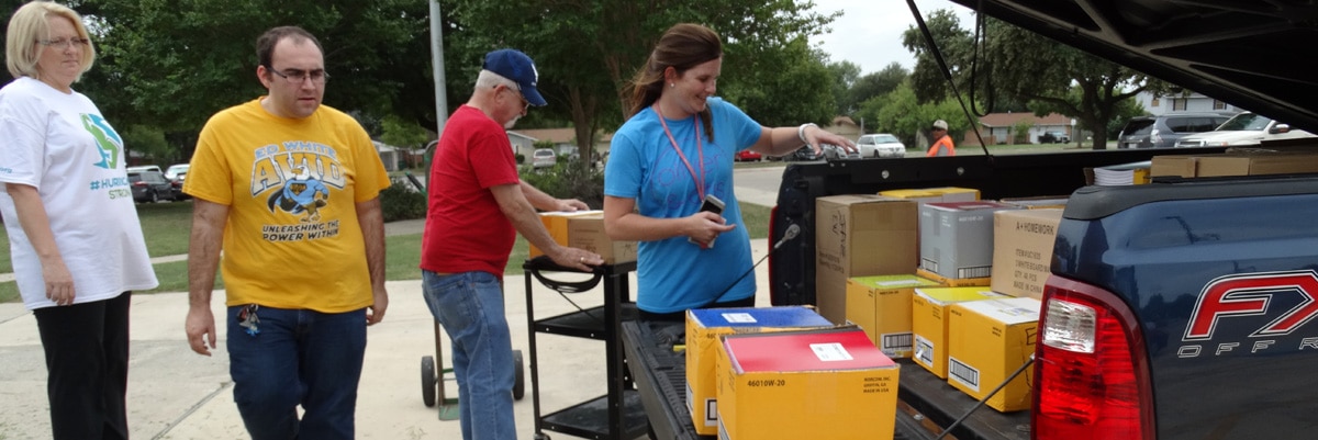 agents helping teachers unload school supplies