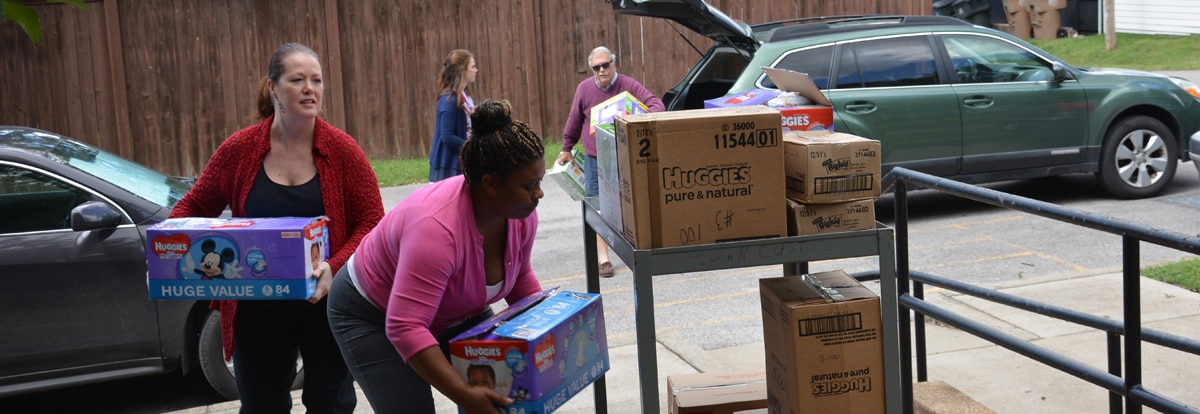 agents and volunteers load diapers for delivery