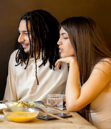 Event planner showing a client the event plan while they sample food.