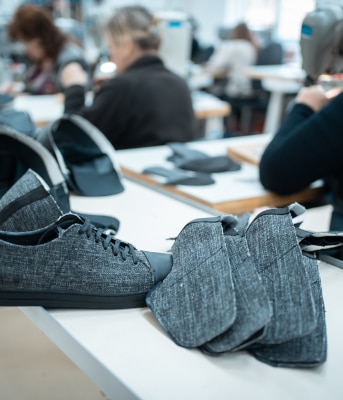 Shoes and pieces of fabric on a table.