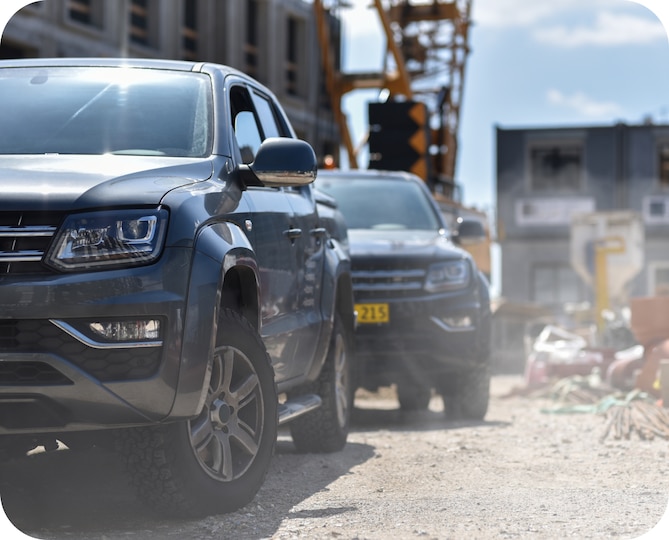 Two cars at a construction site.